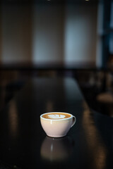 cup of coffee latte art on white cup in mini cafe