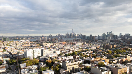 Nighttime views of Jersey City with the dazzling New York City skyline in the background. This urban scene highlights illuminated skyscrapers, waterfront reflections, and iconic architecture.
