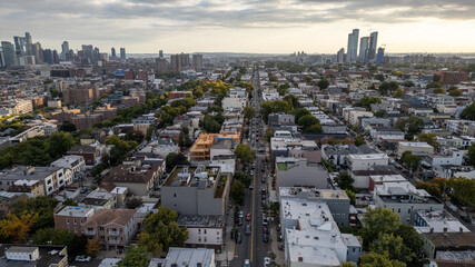 Wide aerial view capturing the neighborhoods of Hoboken and Jersey City, with the iconic New York...