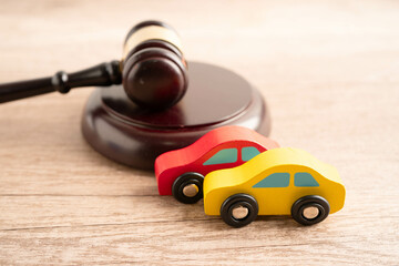 Car accident lawsuit and insurance, Judge hammer with car model.