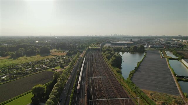 Passenger Train Moving On Railway In Barendrecht, Netherlands. aerial shot