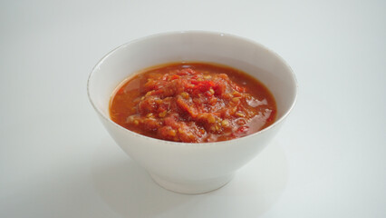 Sambal Tomat or Spicy Tomato Paste served on the bowl. Made of chili, garlic, onion and tomato.