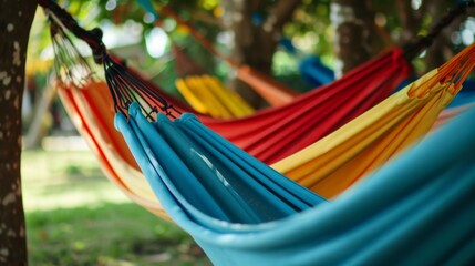 Empty hammocks hang between lush trees in a tropical paradise, inviting vacationers to relax in colorful comfort