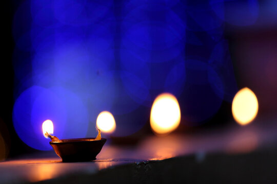A radiant Diwali diya flickers brightly, symbolizing hope, joy, and the triumph of light over darkness.