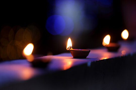 A radiant Diwali diya flickers brightly, symbolizing hope, joy, and the triumph of light over darkness.