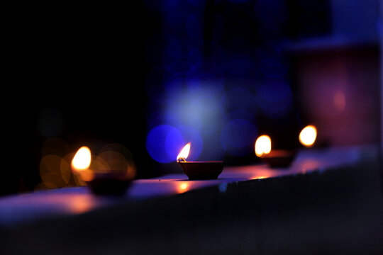 A radiant Diwali diya flickers brightly, symbolizing hope, joy, and the triumph of light over darkness.