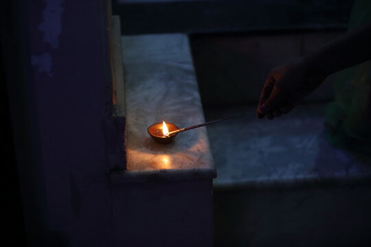 A radiant Diwali diya flickers brightly, symbolizing hope, joy, and the triumph of light over darkness.