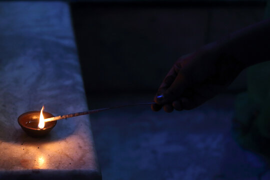 A radiant Diwali diya flickers brightly, symbolizing hope, joy, and the triumph of light over darkness.