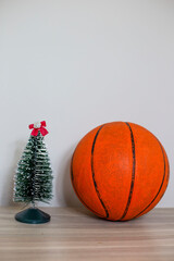 Basket ball aside christmas tree on white background