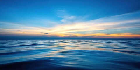 Obraz premium Ocean surface reflecting dark blue sky above, atmospheric perspective, peaceful ocean