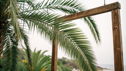 Fototapeta premium Palm tree leaves in shades of forest green and olive hang from a wooden frame like a work of art, leafy greens, verdant landscape, hand-painted artwork