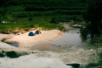 Camping near the waterfall during a long holiday