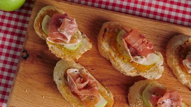 High angle view of spanish tapas of serrano ham, checkered table