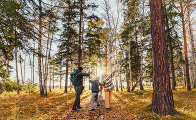 Fototapeta premium family walking in the autumn woods