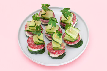Canapes without Bread with Salami, Cucumber, Greens and Cream Cheese on White Plate. Easy Breakfast. Diet Food. Quick and Healthy Sandwiches. Healthy Snacks with Tasty Fillings