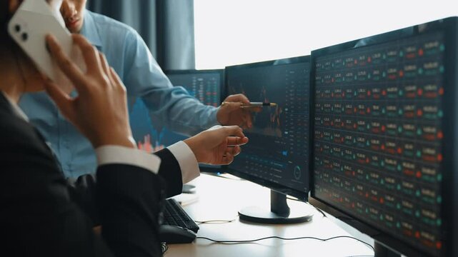 Slow motion business investors in stock trading company analyzing stock exchange marketing looking at monitors analyzing candle bar price for loss and grow up gain and profits. Burgeoning