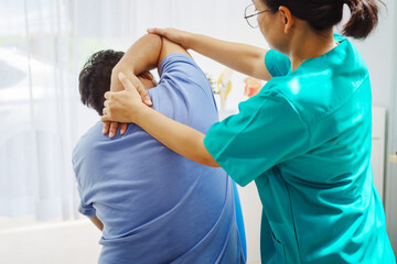 A female doctor performs physical therapy on a male patient in the hospital, using techniques like...
