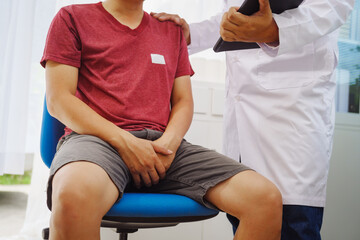 A man consults a doctor in a hospital for a male urinary tract infection. The doctor advises on...