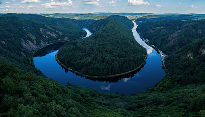 Horseshoe bend in shadow in the Saar River on a sunny spring afternoon in Germany.