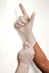 Close up of hands of a surgeon or doctor putting on gloves
