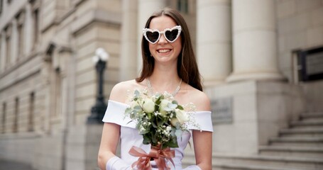 Woman, bride and bouquet with sunglasses in city by court, excited or smile with heart shape for marriage. Person, wedding dress and flowers for celebration, lens or love emoji for milestone in Spain