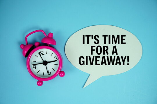 It's time for a giveaway text on speech bubble with alarm clock top view on blue background