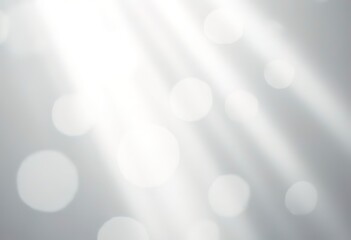 Bright white and gray abstract background with radiating light beams and bokeh effect