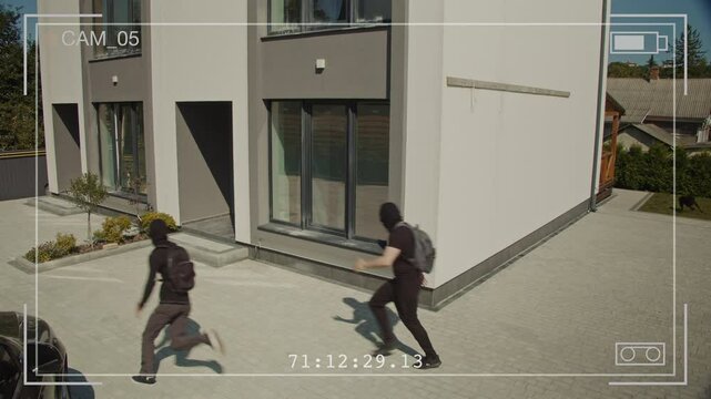 Security Camera Footage Shows Two Armed Burglars Attempt a Break-In but Are Chased Away by a Guard Dog Protecting the Home. Concept of Home Security Pet Protection and the Role of Guard Dogs