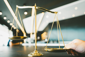Lift the scales of justice concept as a the hand of a person illegally influencing the legal system...