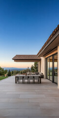 Modern outdoor dining area with sunset views in a serene hillside location