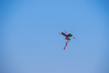 The dance of a eagle kite across the blue sky. Kite flying is a traditional Korean folk game enjoyed from Lunar New Year to Daeboreum, symbolizing sending away misfortune and welcoming fortune.	
