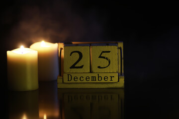 December 25 Date Block with Candles in a Dark Ambience - Cozy Holiday Atmosphere