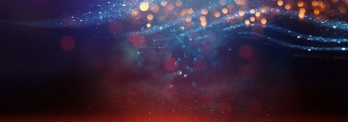 Fototapeta premium abstract glitter black, red, gold , blue lights background. de-focused