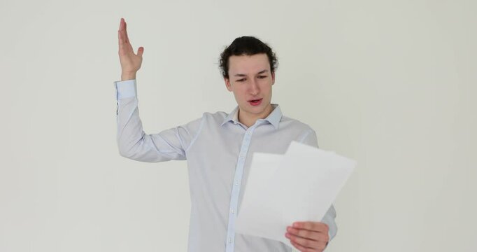 Man with expression reads script on white background