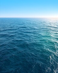 Fototapeta premium Tranquil blue ocean waves under a clear sky