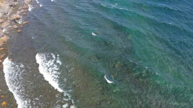 Aerial view of waves on coast of the crystal-clear Huechulafquen glacial lake, Patagonia, Argentina.