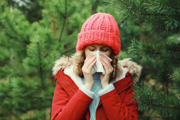 Sick exhausted woman sneezing blow nose using tissue, unhealthy suffering girl feels unwell outdoors