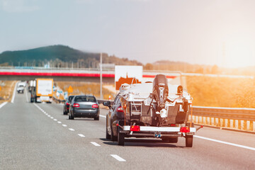 Vehicle pulling motorboat on road