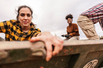 Farmers harvesting olives in a trailer on a cloudy day