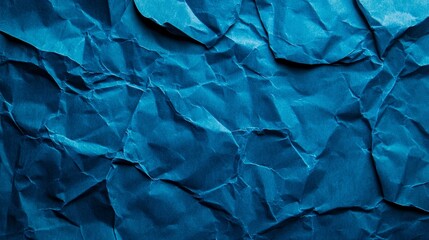 Fototapeta premium Crumpled blue paper texture background, a versatile backdrop for design projects with wrinkled and folded effects