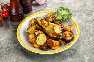 Roasted young zucchini in the plate