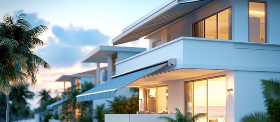 Fototapeta premium Stock photo of a modern beach city home, white, blue roof, gray awning.