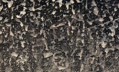 Dirt on the body of a black car. Abstract background