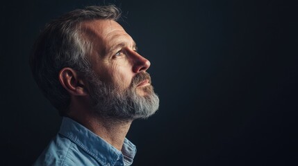 Obraz premium A thoughtful studio portrait of a man gazing off to the side, lost in contemplation