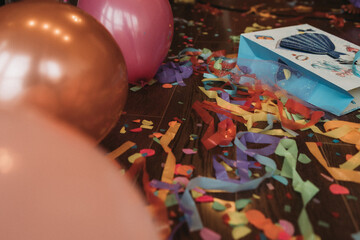 Fototapeta premium Confetti and balloons on the floor, birthday
