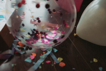 Confetti and balloons on the floor, birthday
