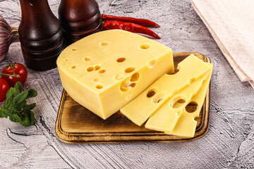 Maasdam cheese piece with slices