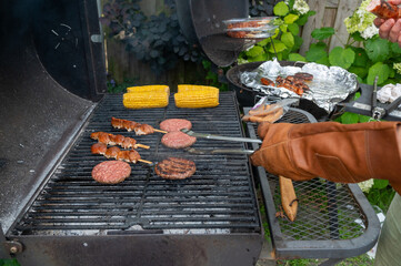 Backyard Barbecue Grill with Juicy Burgers and Fresh Corn