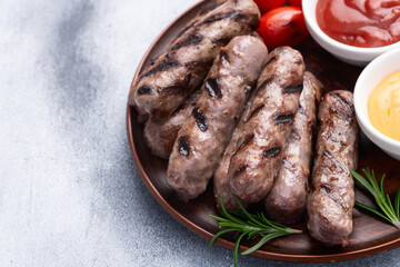 Grilled beef sausages with rosemary sauce and tomatoes photography . Top view