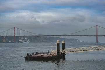 Luxury cruiseship cruise ship liner Sirena arrival into Lisbon port with statue and suspension bridge